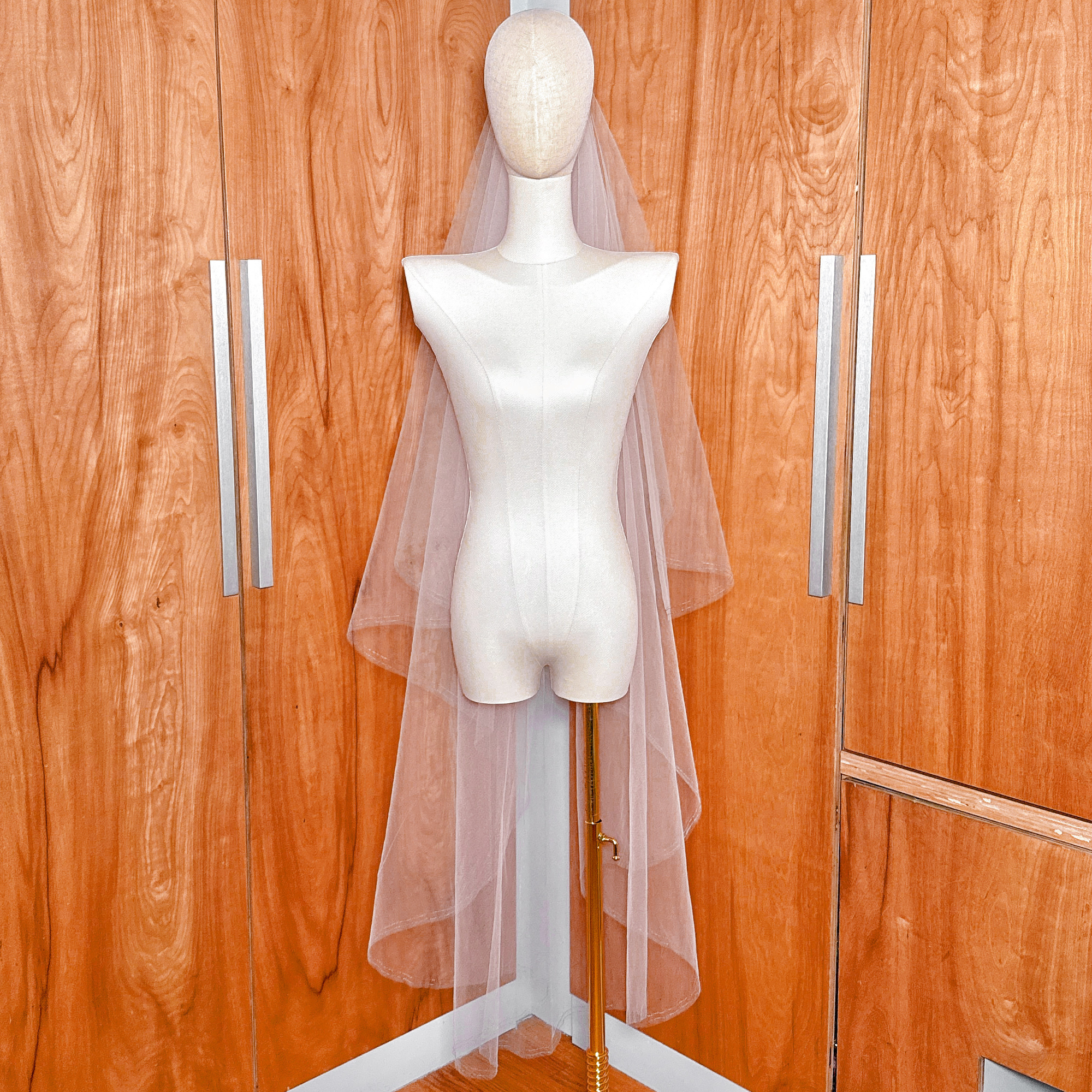 Two tier wedding veil with blue metallic edge and blusher displayed in a classic waltz length.