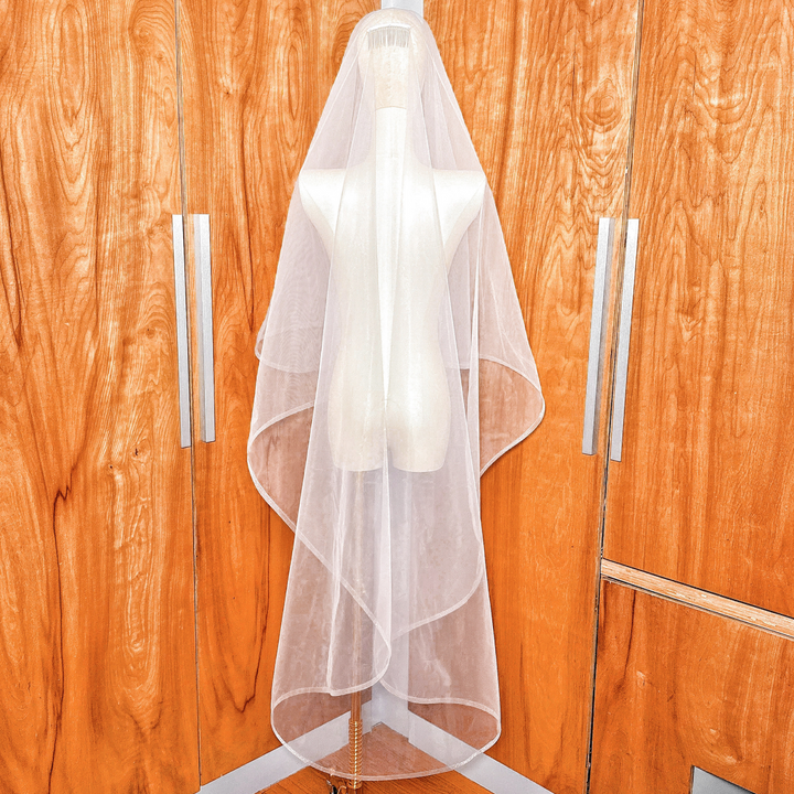 Back view of a two tier wedding veil with 1/2" horsehair trim in waltz length displayed on a bridal mannequin.
