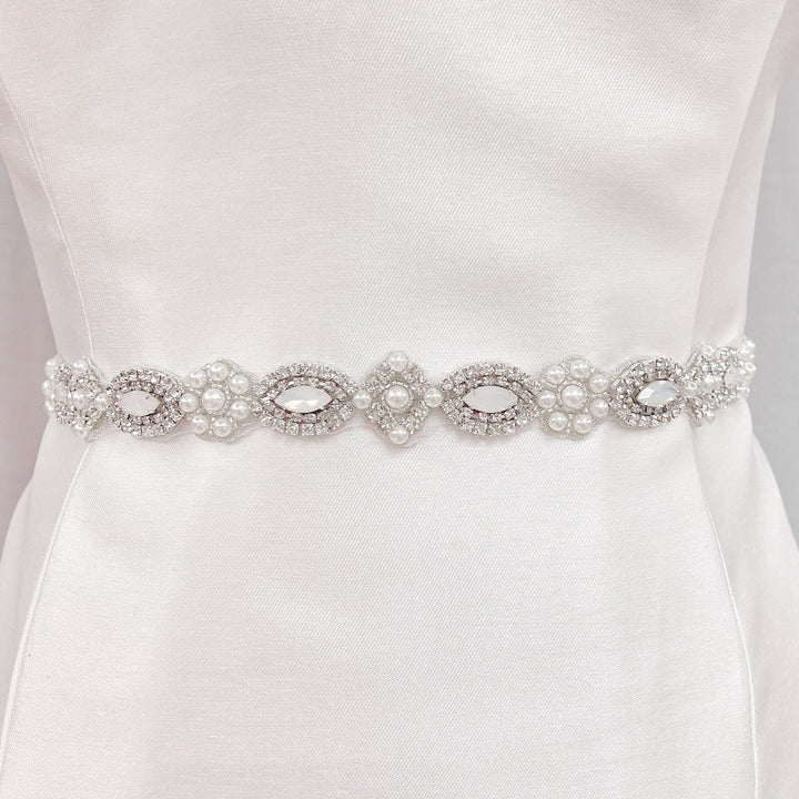 Art Deco beaded wedding belt with intricate silver geometric crystal patterns on a display bridal mannequin.