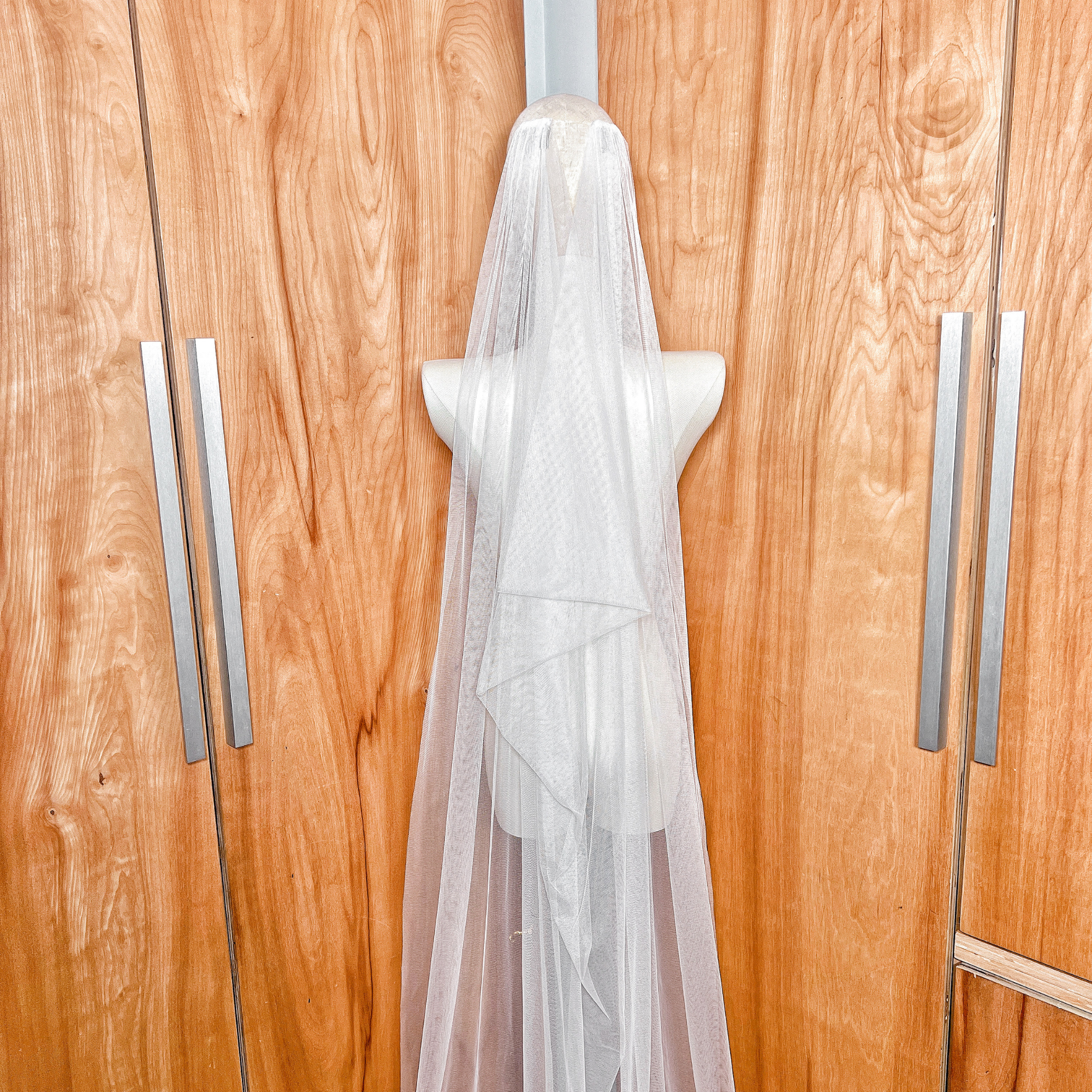 Elegant vintage style boho draped wedding veil hanging gracefully to highlight the silhouette.