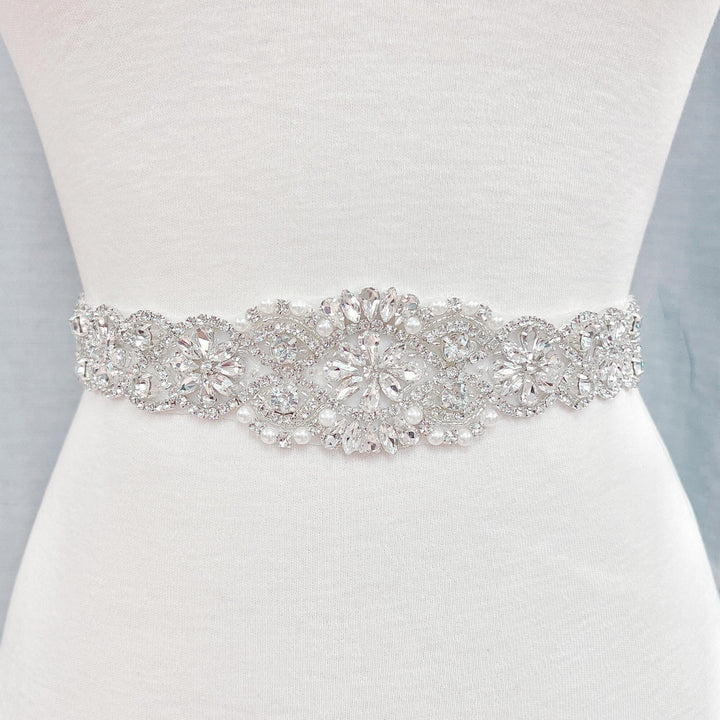 Close-up shot of the hand-stitched embroidery on the Vintage Pearl Beaded Bridal Belt showing ivory pearls and silver rhinestones.