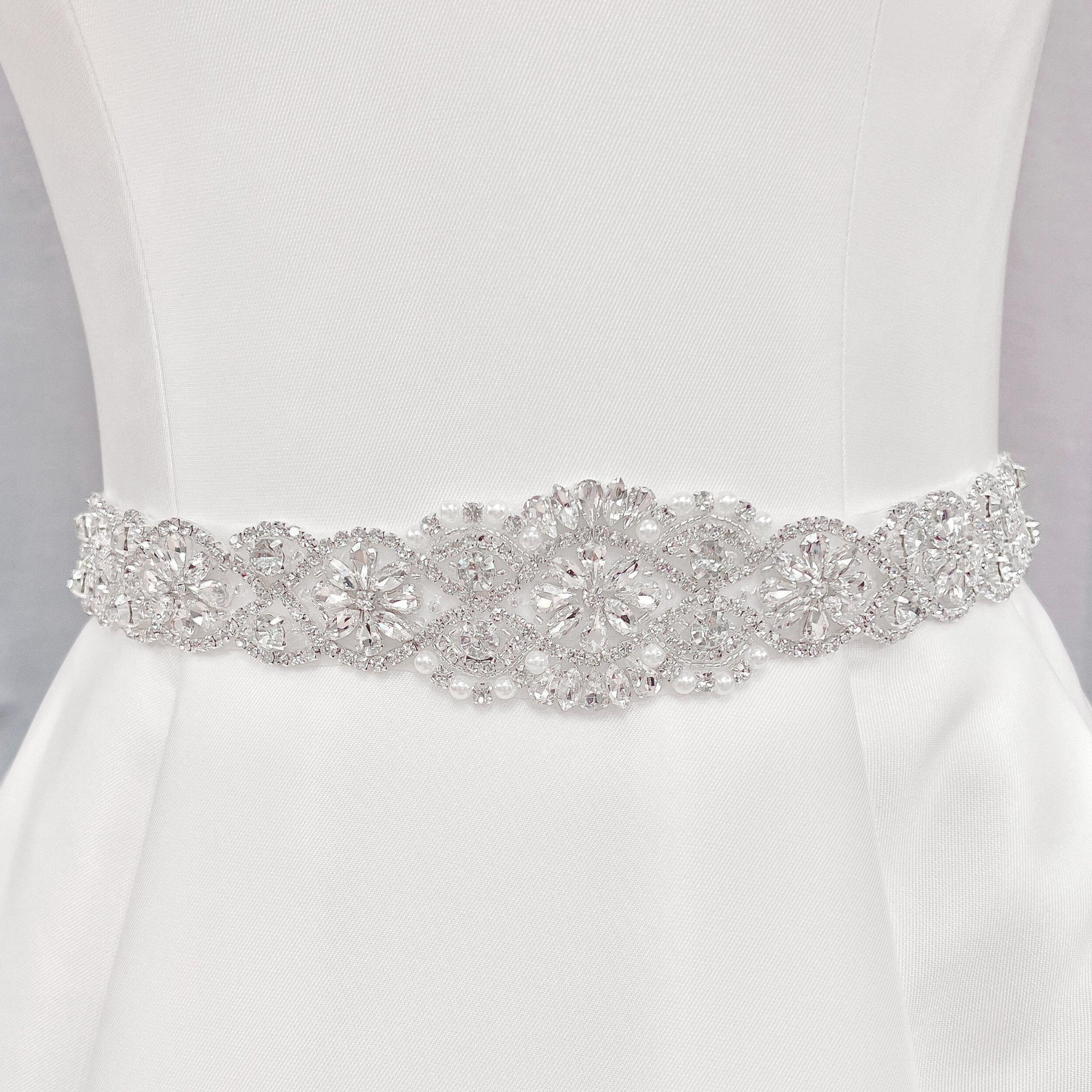 Vintage Pearl Beaded Bridal Belt with intricate crystal accents displayed on a white bridal gown bodice.