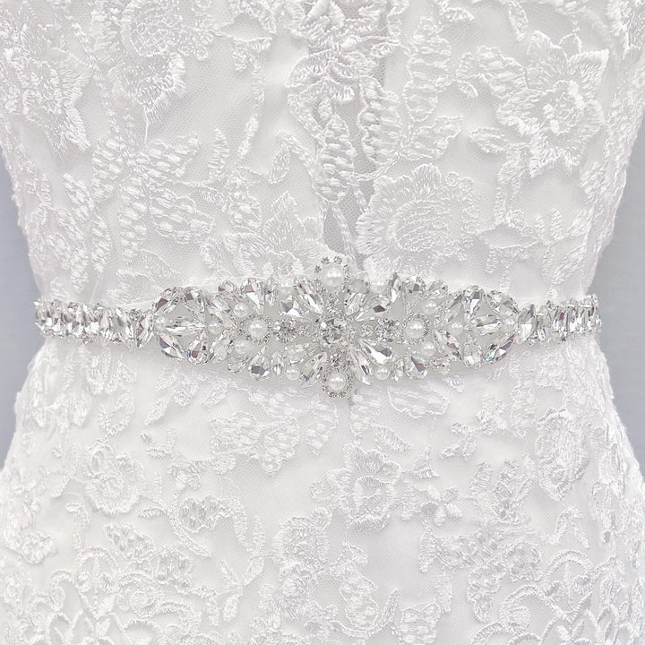 Vintage rhinestone and pearl bridal belt displayed on a mannequin.