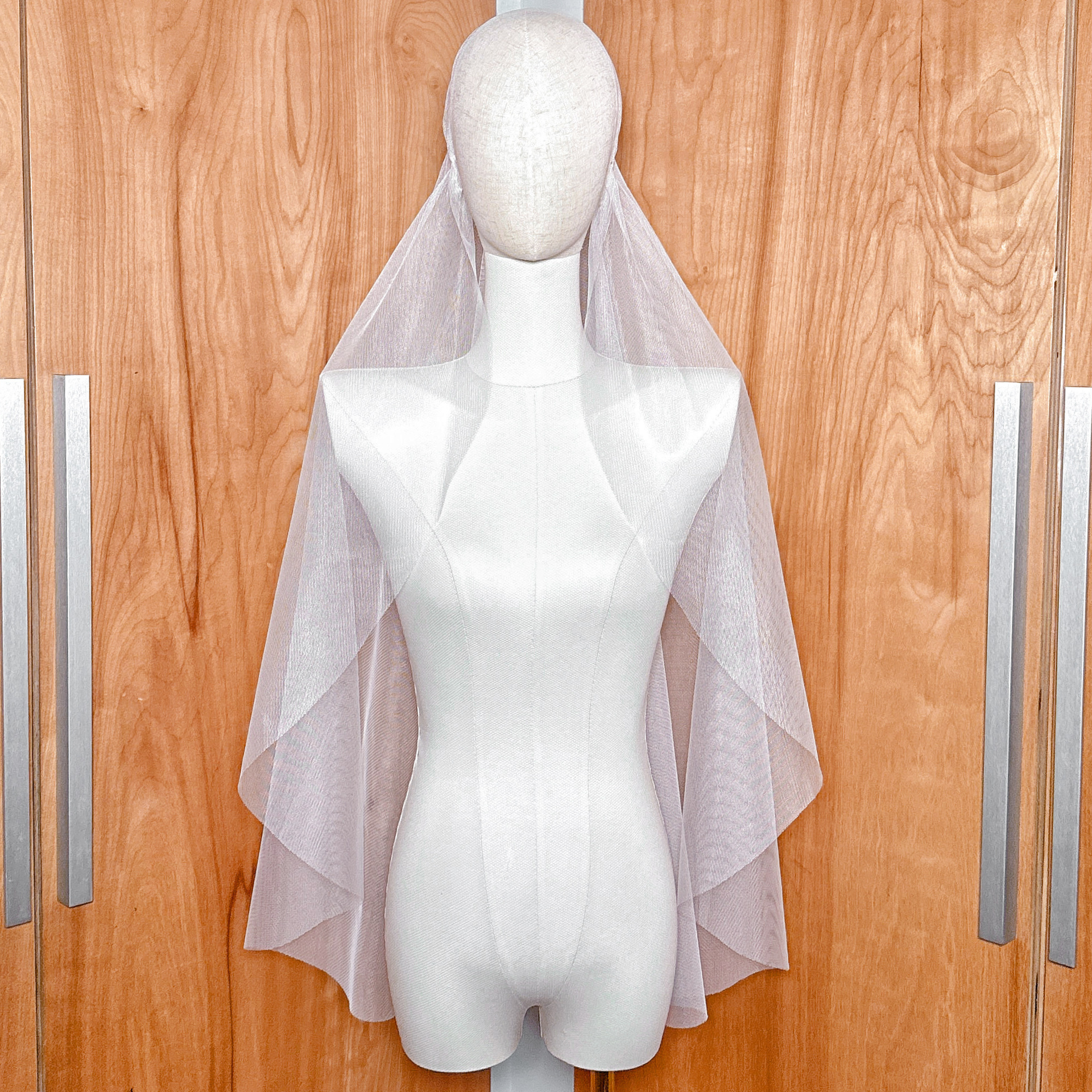 Vintage style Juliet cap veil in fingertip length with a raw edge, displayed on a bridal mannequin.