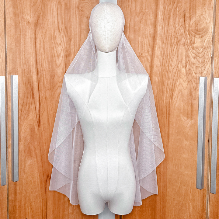 Vintage style Juliet cap veil in fingertip length with a raw edge, displayed on a bridal mannequin.