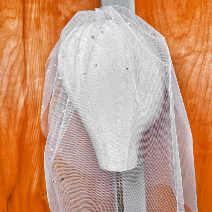 Vintage style tulle birdcage wedding veil with rhinestones and pearls showcasing the full face cover length.