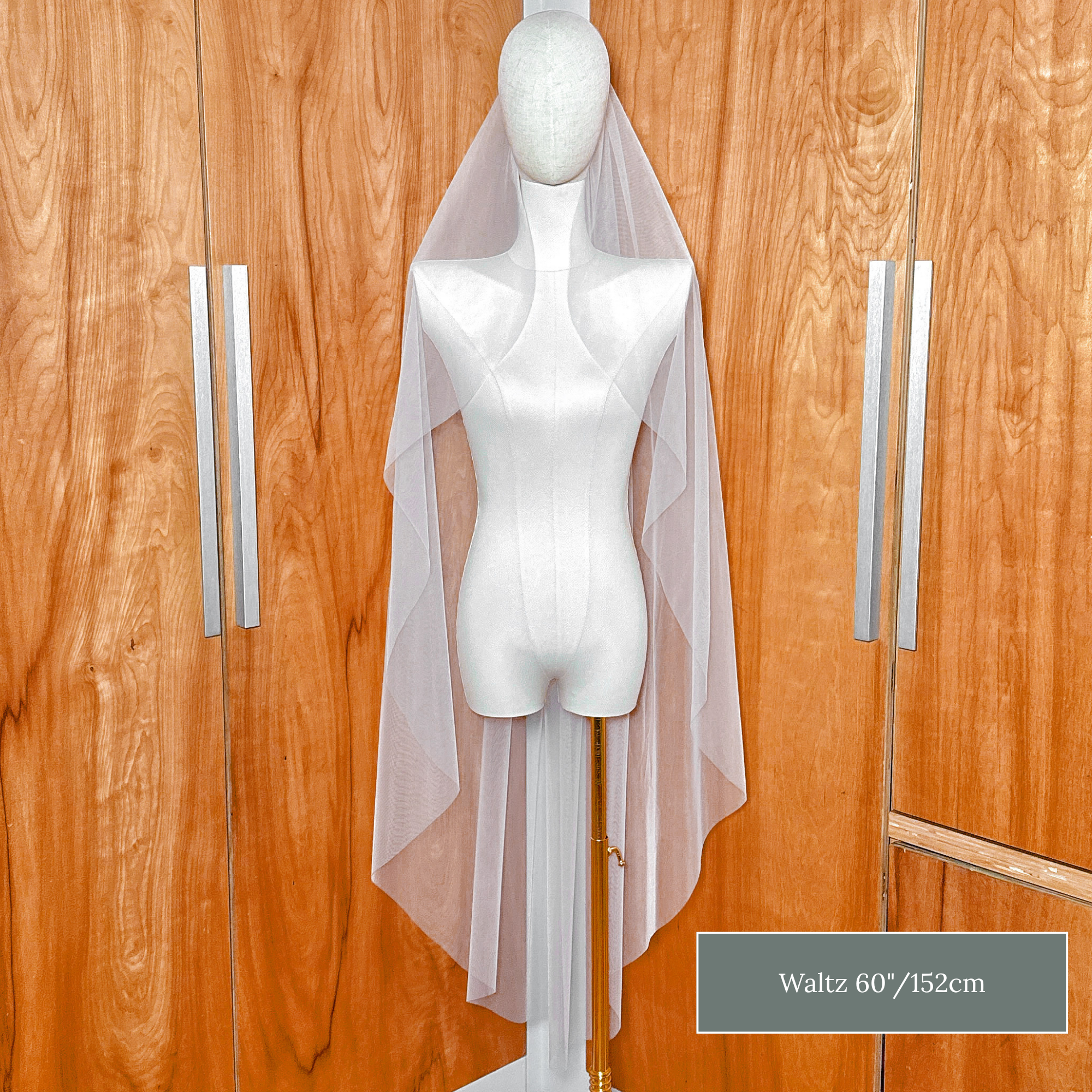 Romantic waltz length raw edge cascade wedding veil falling between the knee and ankle.