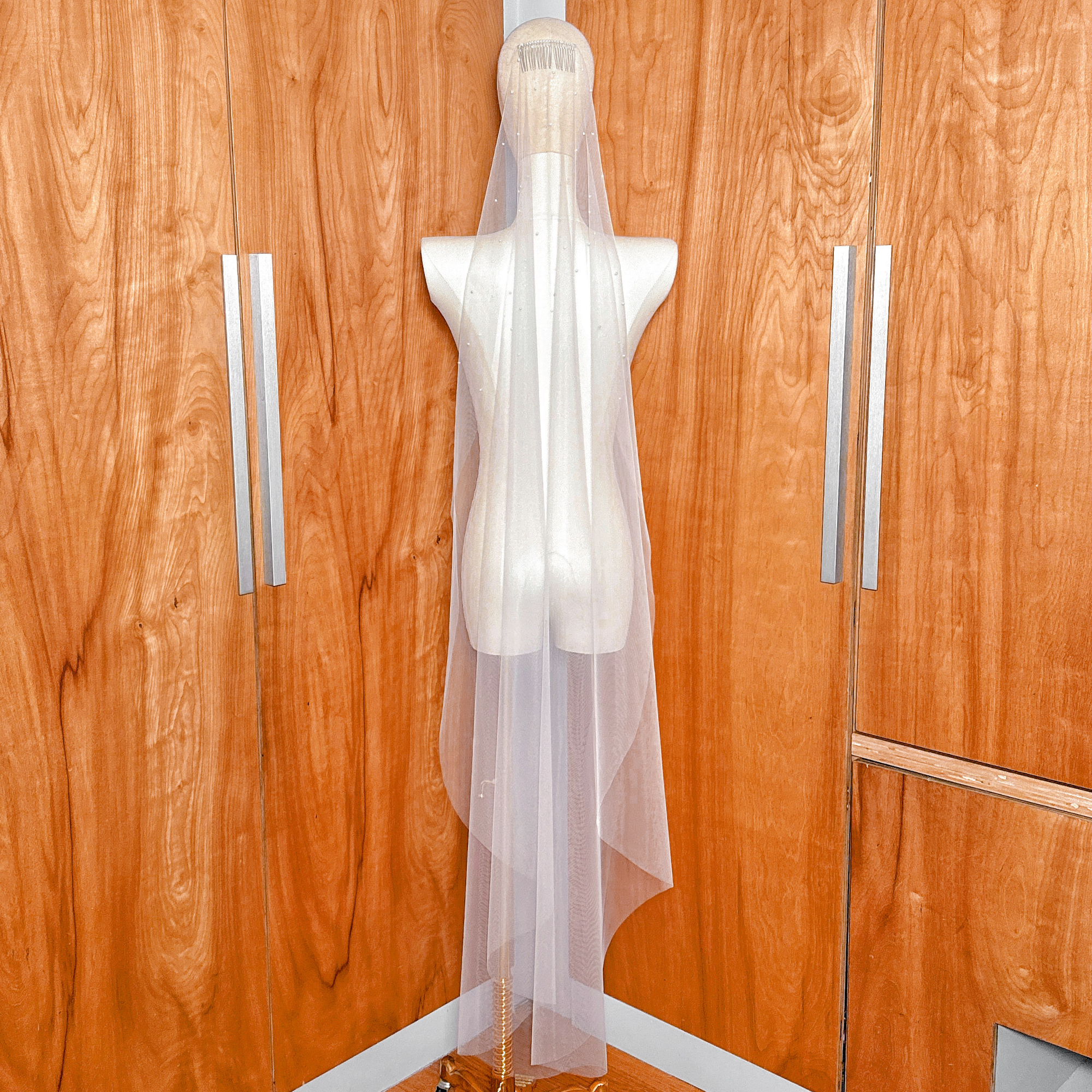 Lightweight waltz length wedding veil with a scattered pearl design.