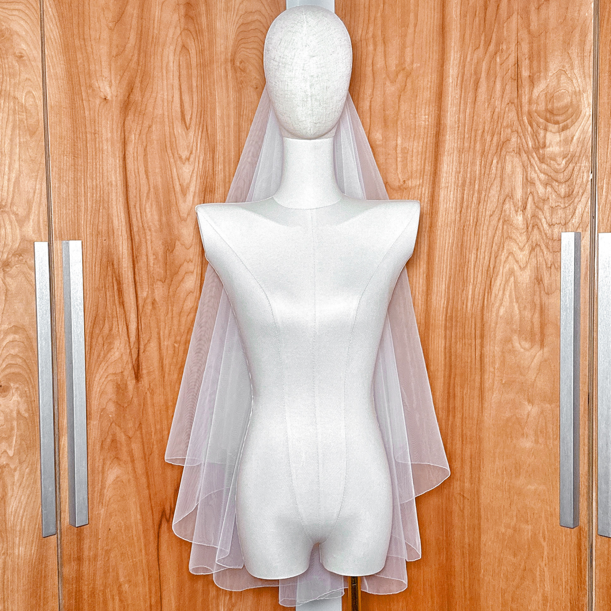 Sheer wedding Pencil Edge Two Tier Fingertip Length Veil showing the lightweight double-layer drape.