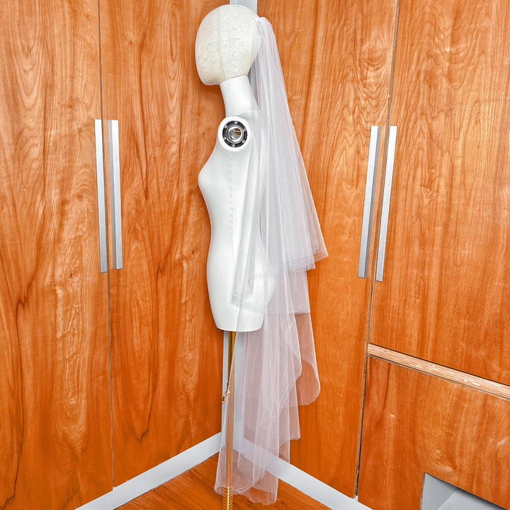 Waltz length bridal veil with two tiers, a sheer blusher, and a distinctive blue metallic bordered trim.
