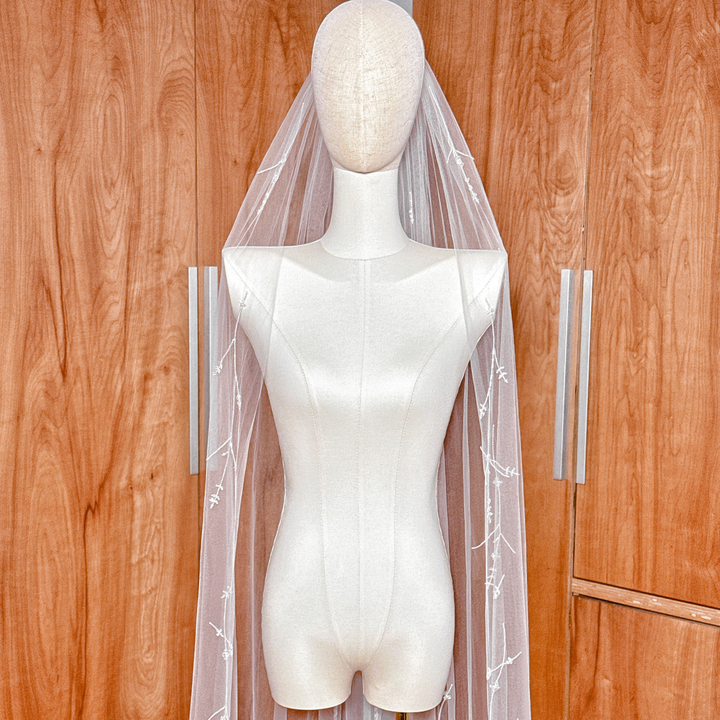 White cathedral length 3D floral embroidered veil with crystals and hand-sewn petals.