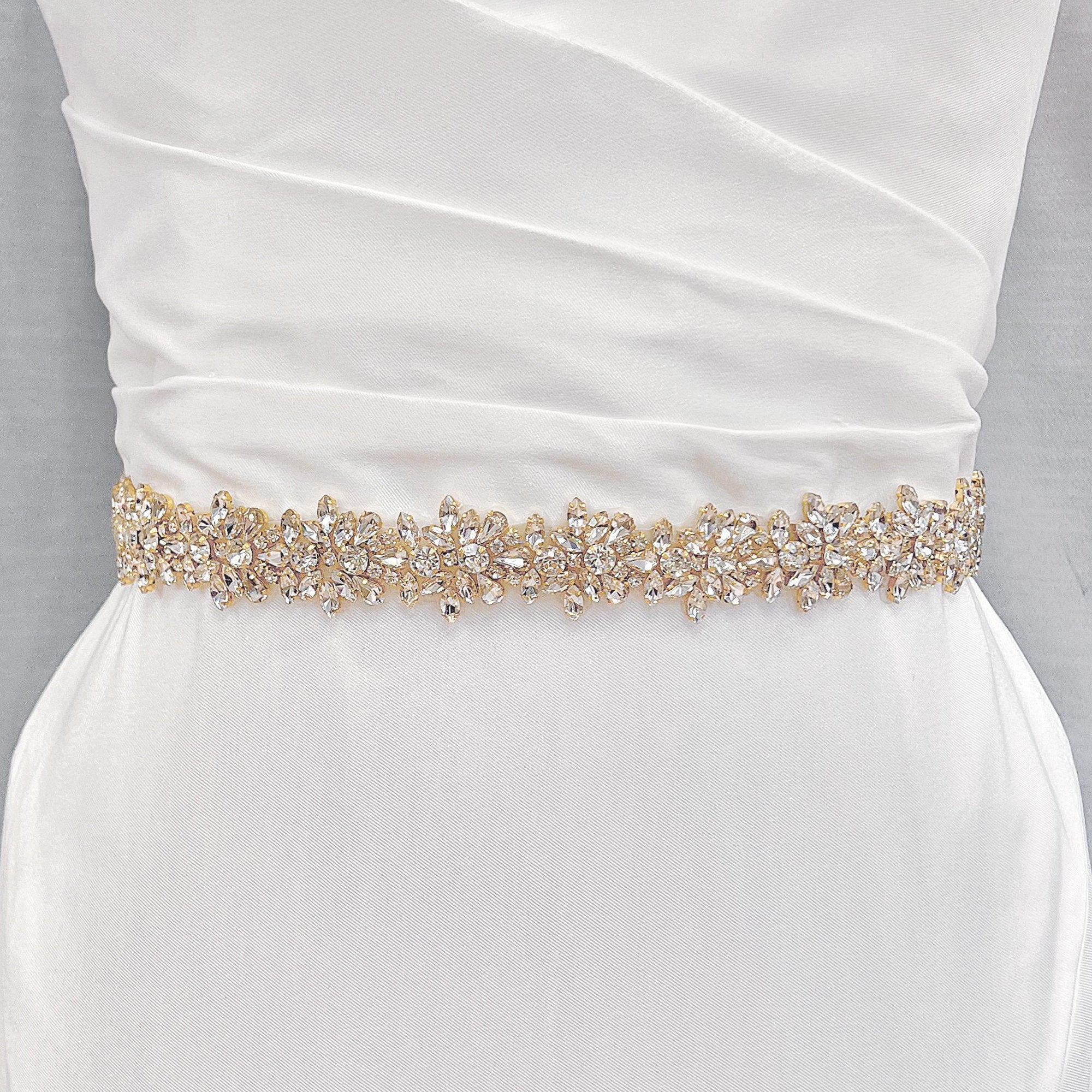 Detailed close-up of the gold beadwork on the wide beaded bridal belt.