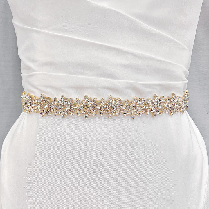 Detailed close-up of the gold beadwork on the wide beaded bridal belt.