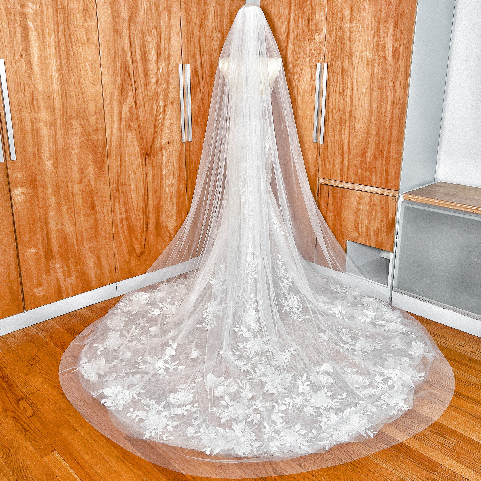 Detail shot of the secure metal comb attachment on the wide raw edge cathedral wedding veil.