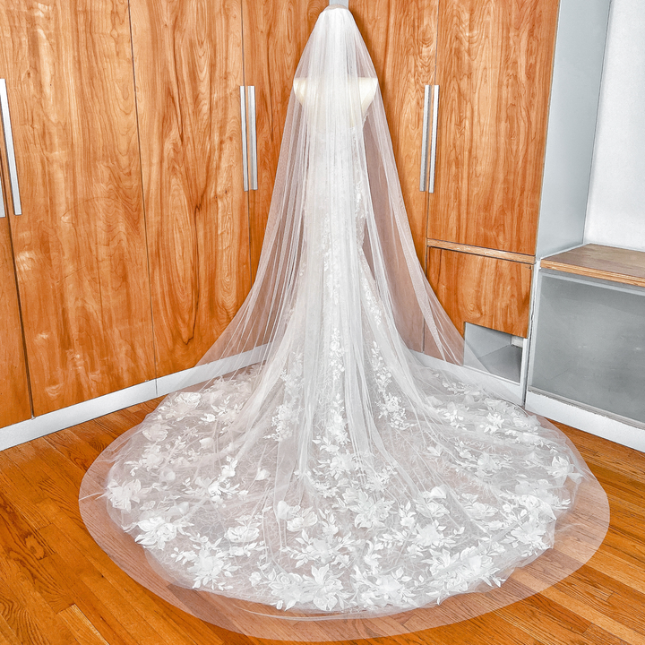 Detail shot of the secure metal comb attachment on the wide raw edge cathedral wedding veil.