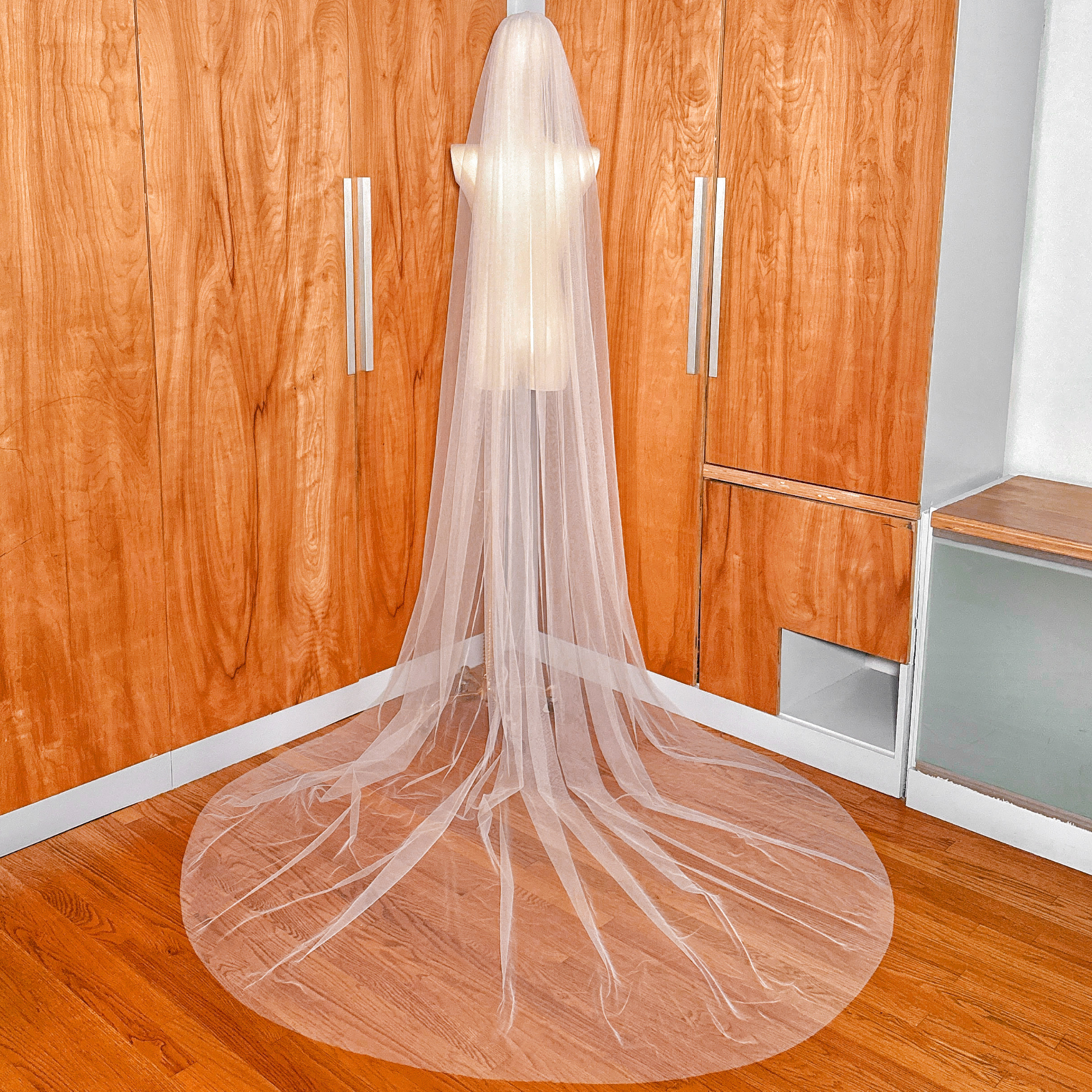 Detailed texture of the high-quality transparent tulle used in this wide raw edge cathedral veil.